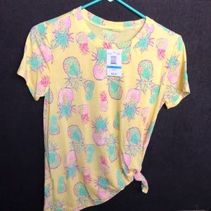 yellow t shirt tied to the side with pineapples